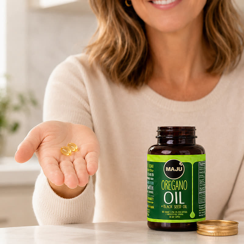 Two softgels held in an open hand