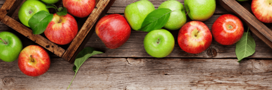 Red and green apples on wooden background