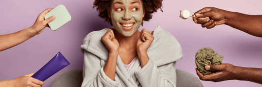 Woman with green face mask being handed skincare options by four different arms, purple background