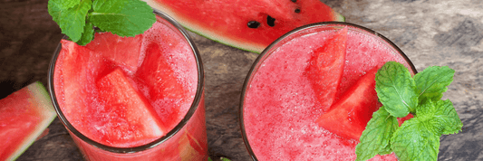 Twi pink watermelon smoothies with green mint leaves
