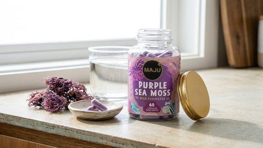 Open jar of MAJU purple sea moss capsules with two capsules in a dish and dried sea moss