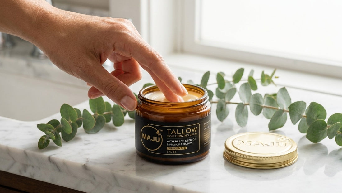 Fingers dipping into an open jar of MAJU tallow moisturizing balm