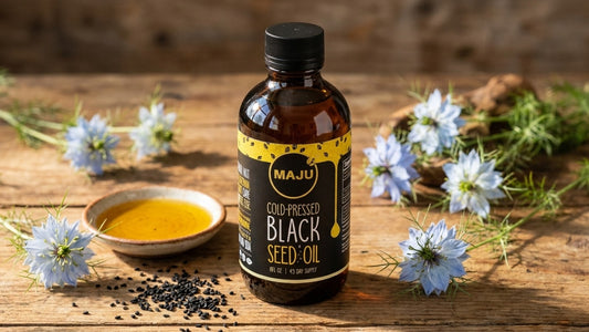 MAJU black seed oil bottle with nigella seeds, oil dish and nigella flowers
